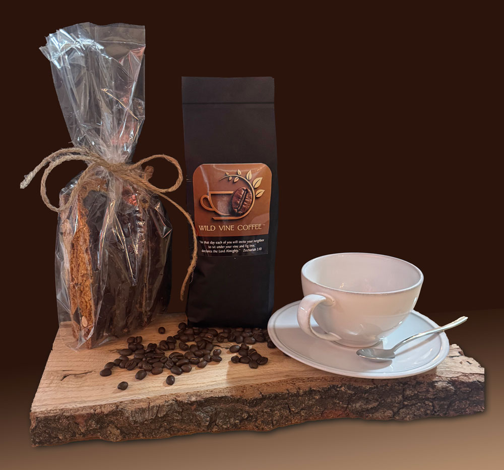 Wild Vine Coffee — a bag of freshly roasted beans and biscotti beside a cup of coffee on a live-edge board